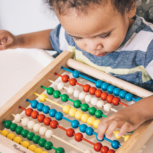 What is a montessori toy? A children playing with an ábaco
